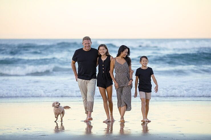 Happy family and dog on a beach